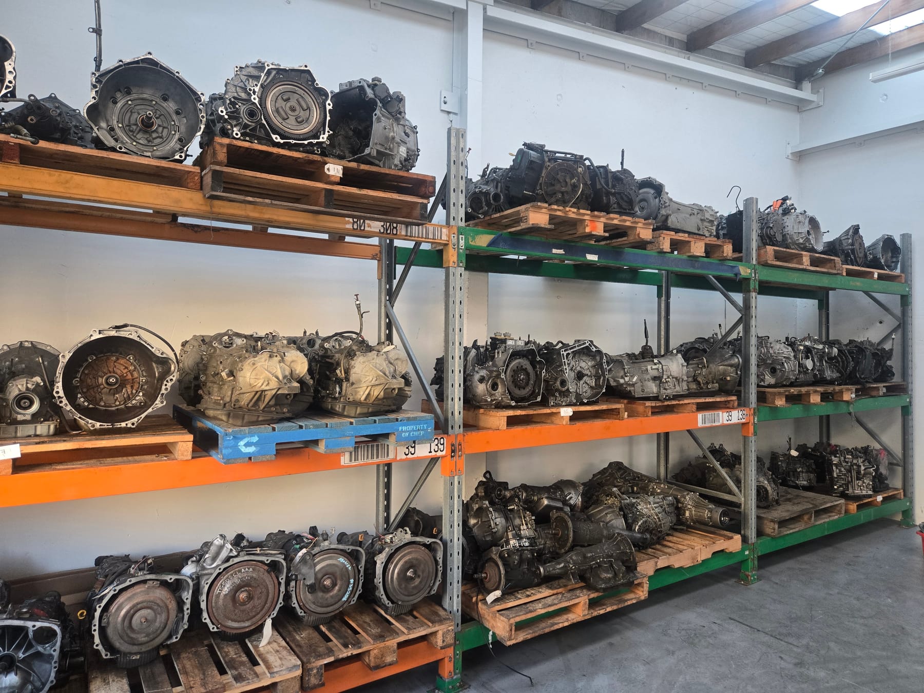 Workshop racking stacked with automatic transmissions and gearboxes for a range of makes