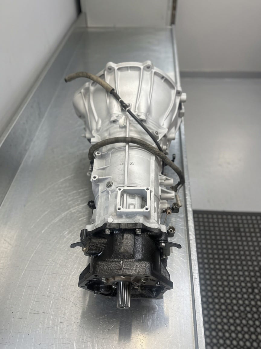 Rebuilt automatic transmission viewed end-on along a workshop bench